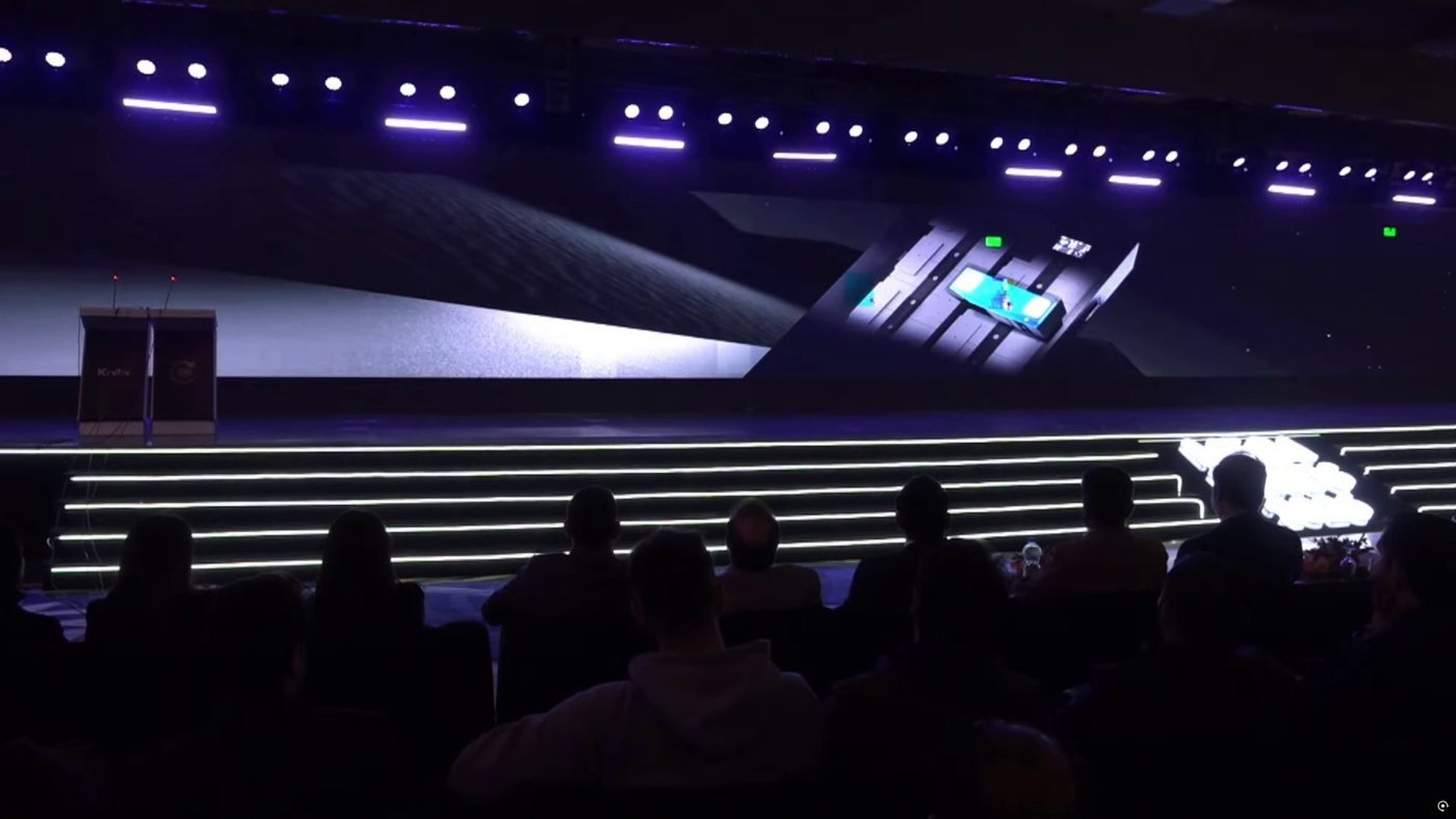 A stage event screen displaying a 3D product animation